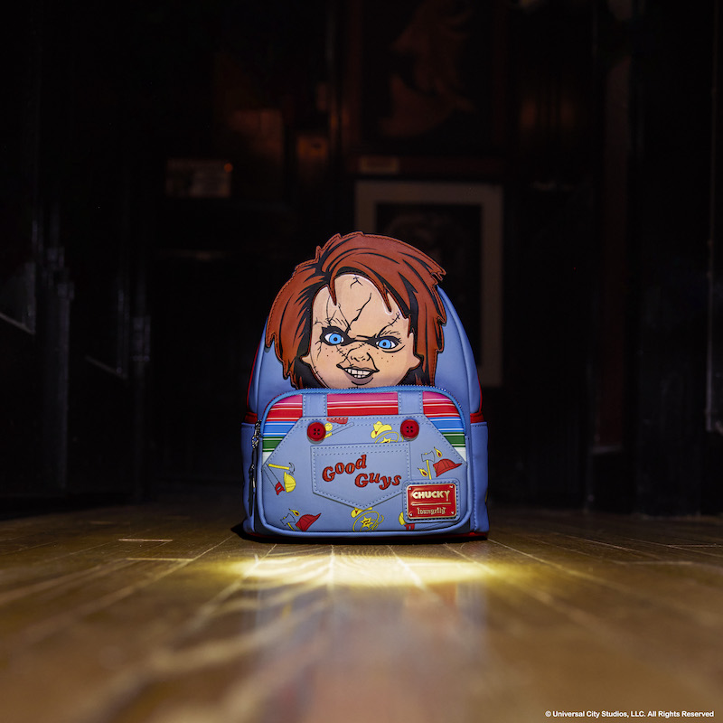 Image of our Chucky Cosplay Lenticular Mini Backpack sitting at the end of a hallway with a spotlight on it, with darkness around it